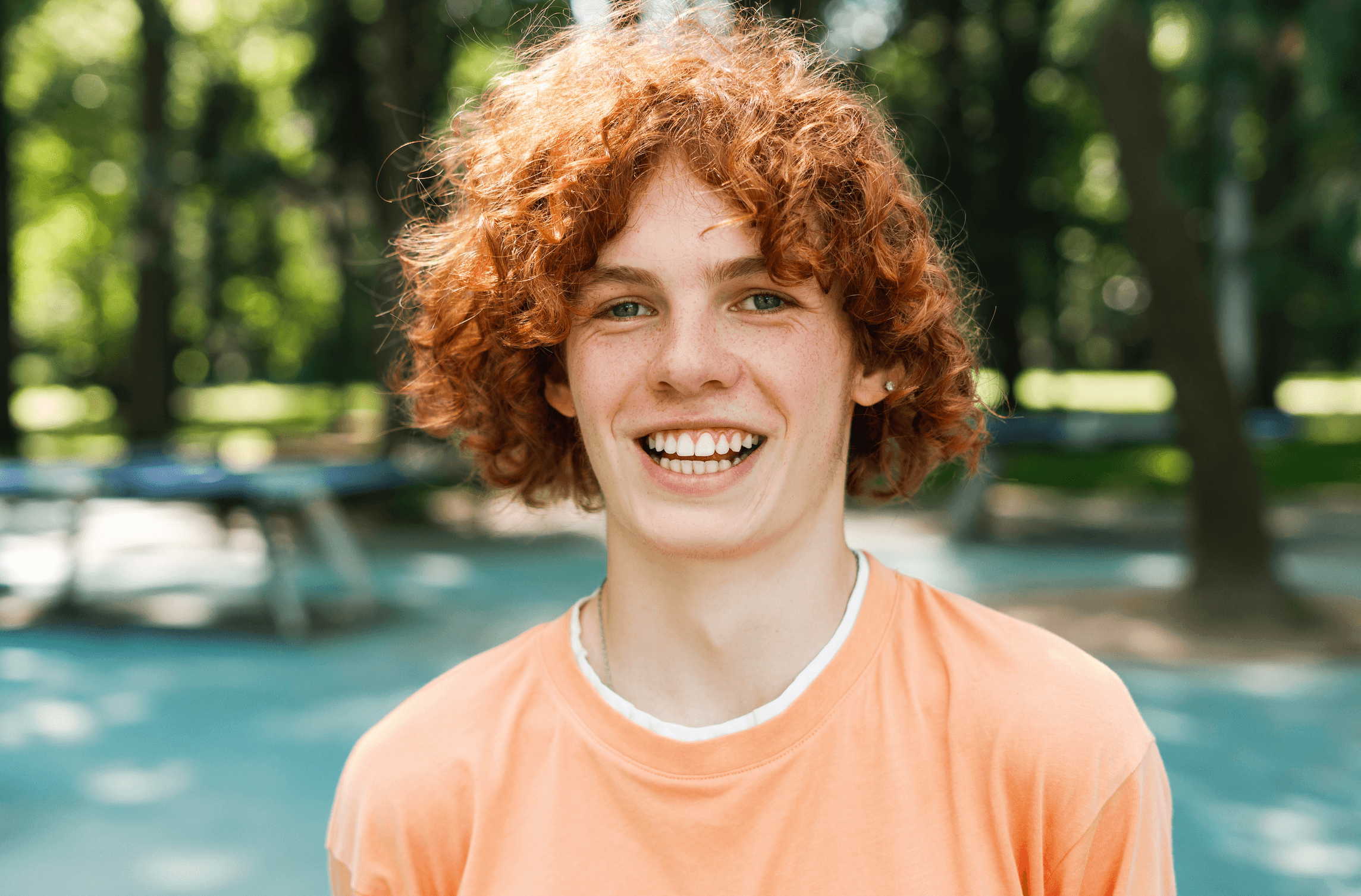 Smiling red-haired teen enjoying the outdoors, symbolizing the confidence, comfort, and personalized care delivered through the Palencia Promise